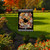 Briarwood Lane Fall Pumpkin Wreath Floral Garden Flag with black and white gingham border outdoors.