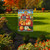 Briarwood Lane Pumpkin Pickup Scarecrow Fall Garden Flag with colorful pumpkin and scarecrow design outdoors.