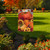 Briarwood Lane Autumn Pumpkin Trio Garden Flag with sunflowers and fall leaves on a garden lawn.