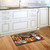 Briarwood Lane small printed doormat with colorful jack-o-lanterns on kitchen floor, festive seasonal autumn decor.