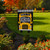 Briarwood Lane Back to School burlap garden flag with colorful school bus design on a lawn.