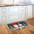 Briarwood Lane Christmas Gnomes Humor Doormat with colorful gnome design on kitchen floor.