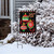 Briarwood Lane small printed Christmas garden flag with colorful ornaments on a decorative holiday display.