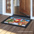 Briarwood Lane Barnyard Snowman Christmas Doormat on a porch with colorful holiday design.