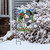 Briarwood Lane small printed Checkered Snowman Winter Garden Flag on a snowy lawn display stand.
