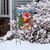 Briarwood Lane Barnyard Snowman Christmas Garden Flag on a snowy lawn display with colorful festive design.