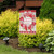 Briarwood Lane Valentine's Wreath Hearts Garden Flag with pink hearts on a rustic farmhouse yard display.