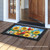 Briarwood Lane colorful doormat with cardinals, sunflowers, and butterflies on a picket fence background.