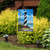 Briarwood Lane Hatteras Lighthouse garden flag depicts coastal scene with sailboat, seagulls, and shoreline.