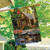 Briarwood Lane Lakeside Cabin House Flag with colorful outdoors scene of cabin, deer, ducks, and canoe.