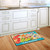 Briarwood Lane Surfside Flip Flops Doormat on a kitchen floor with beach themed design.