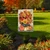 Briarwood Lane Autumn Bouquet Garden Flag with vibrant fall flowers and pumpkins design outdoors.