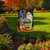 Briarwood Lane Costumed Pumpkins Garden Flag with colorful Halloween characters on a garden lawn display.