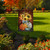 Briarwood Lane garden flag with Patterned Pumpkins And Sunflowers design in a garden setting outdoors.