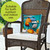 Briarwood Lane Fall At The Beach Pillow on a wicker chair with white cushion and pumpkins.