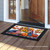 Briarwood Lane American Autumn Patriotic Doormat with colorful fall design and black border on wooden porch.