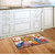 Briarwood Lane American Autumn Patriotic Doormat with sunflowers, pumpkins, and American flag design on wooden floor.