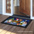 Briarwood Lane Happy Holiday Gnomes doormat with colorful Christmas gnomes on a black background.