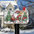 Briarwood Lane Wagon Gnome Mailbox Cover with gnome on red wagon amidst Christmas trees and decor.