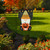 Briarwood Lane Halloween Gnome Burlap Garden Flag with orange pumpkin and white beard outdoors.