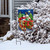 Briarwood Lane Dashing Through the Snow garden flag with snowmen on a sleigh at night.