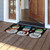 Briarwood Lane Snowman Trio Coir Doormat with snowmen and snowflakes on a wooden porch floor.