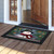 Smiling Snowman Doormat by Briarwood Lane, black border with festive snowman design on wooden porch.