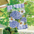 Briarwood Lane Dragonfly and Hydrangea house flag with blue flowers and green dragonfly design.