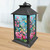 Briarwood Lane Springtime Hummingbirds Lantern with colorful floral design and hummingbirds on a wooden table.