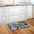 Briarwood Lane Goldfinches and Hydrangea doormat with colorful birds and flowers on kitchen floor.