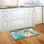 Briarwood Lane Dogs Spoiled Here doormat with colorful dog design on kitchen floor.