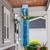 Briarwood Lane Seaside Escape Windsock Wind Twister hanging from a house porch outdoors.