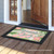 Briarwood Lane Welcome Beach Flip Flops doormat with pink flamingos and green palm leaves design.