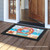 Briarwood Lane Coral Wreath Doormat with beach scene and welcome text on wooden porch floor.