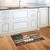 Briarwood Lane Patriotic Birdhouse Doormat on wooden floor in front of white kitchen cabinets.