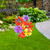 Briarwood Lane Whimsy Flowers Metal Art garden decoration with colorful flowers and butterflies on green lawn.