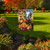 Briarwood Lane Fall Chair Garden Flag with pumpkins, sunflowers, and flowers design on a garden lawn.