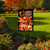 Briarwood Lane Gobble Turkey Garden Flag with cartoon turkey and festive fall design outdoors.