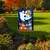 Briarwood Lane Halloween Haunting Garden Flag with ghosts, pumpkins, and haunted house design displayed outdoors.