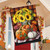 Briarwood Lane Autumn Arrangement House Flag with sunflowers, pumpkins on plaid background hanging on porch.