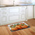 Country Pumpkins Doormat on kitchen floor with white cabinets and wood flooring, featuring orange pumpkins.