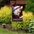 Patriotic garden flag with eagle, American flag, and "God Bless America" text on a garden stand.