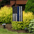 Honor Protect Serve Garden Flag with thin blue line American flag design outdoors in garden setting.