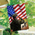 Saluting Soldier House Flag with American flag and eagle design hanging from a house exterior.