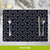 Bold Patterns Placemat, navy blue with gold geometric design, 4-pack, silverware arranged on top.