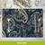 Bold Patterns Placemat with navy blue background and orange, green, and white paisley designs, silverware on top.