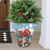Large Winter Watering Can Planter with Christmas tree, cardinals, and red flowers on front porch.