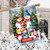 Snow Family House Flag with colorful snowmen and welcome sign on snowy background outdoors.