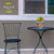 Briarwood Lane Farm Fresh Flowers small planter on black metal table beside chair outdoors.