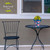 Briarwood Lane Abstract Floral Small Planter with yellow flowers on a black metal table and chair.